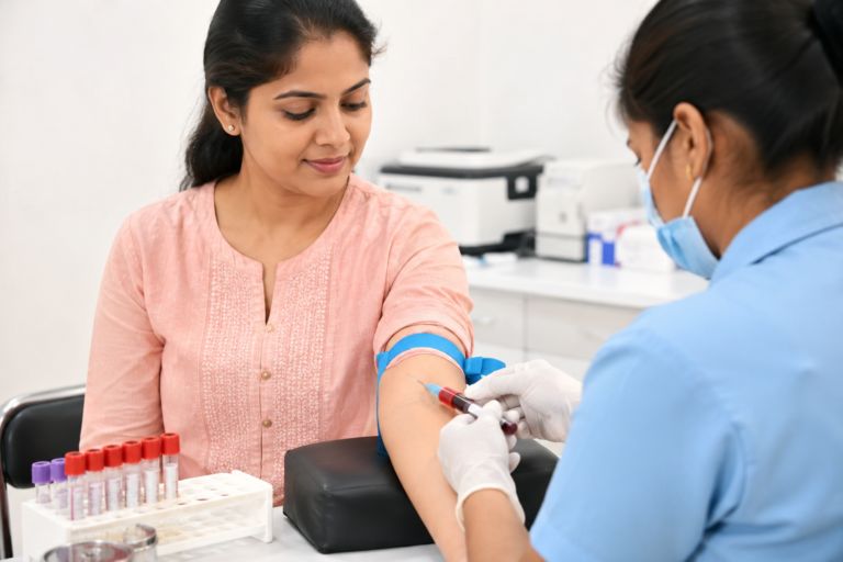 Indian woman getting a blood test in a clinic as part of routine women’s health screening.